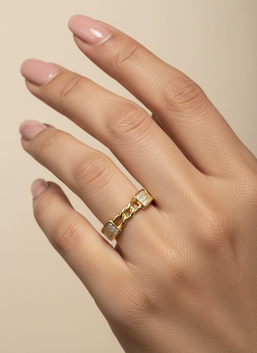 SHE BEAUTY gold-toned anti-tarnish ring featuring a central chain link design with sparkling AD stone accents.