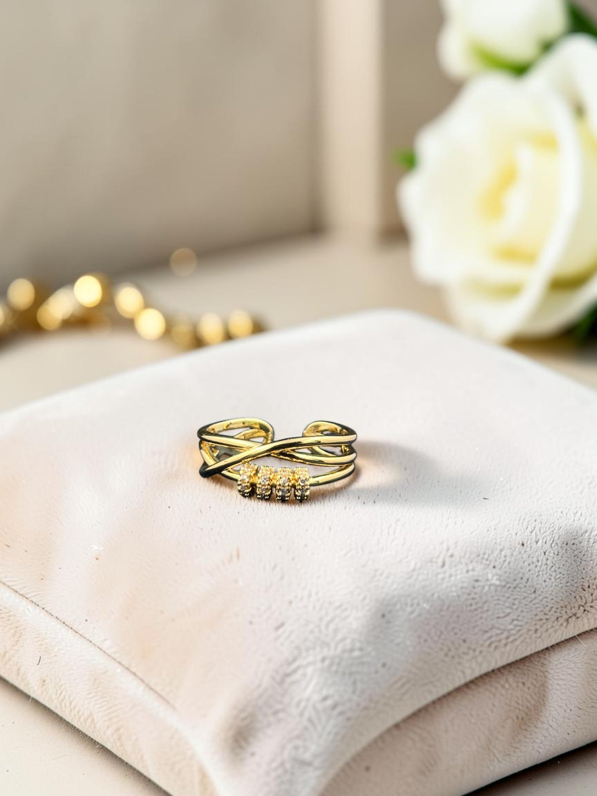 SHE BEAUTY gold-tone anti-tarnish ring featuring a crisscross band design with sparkling AD stone accents