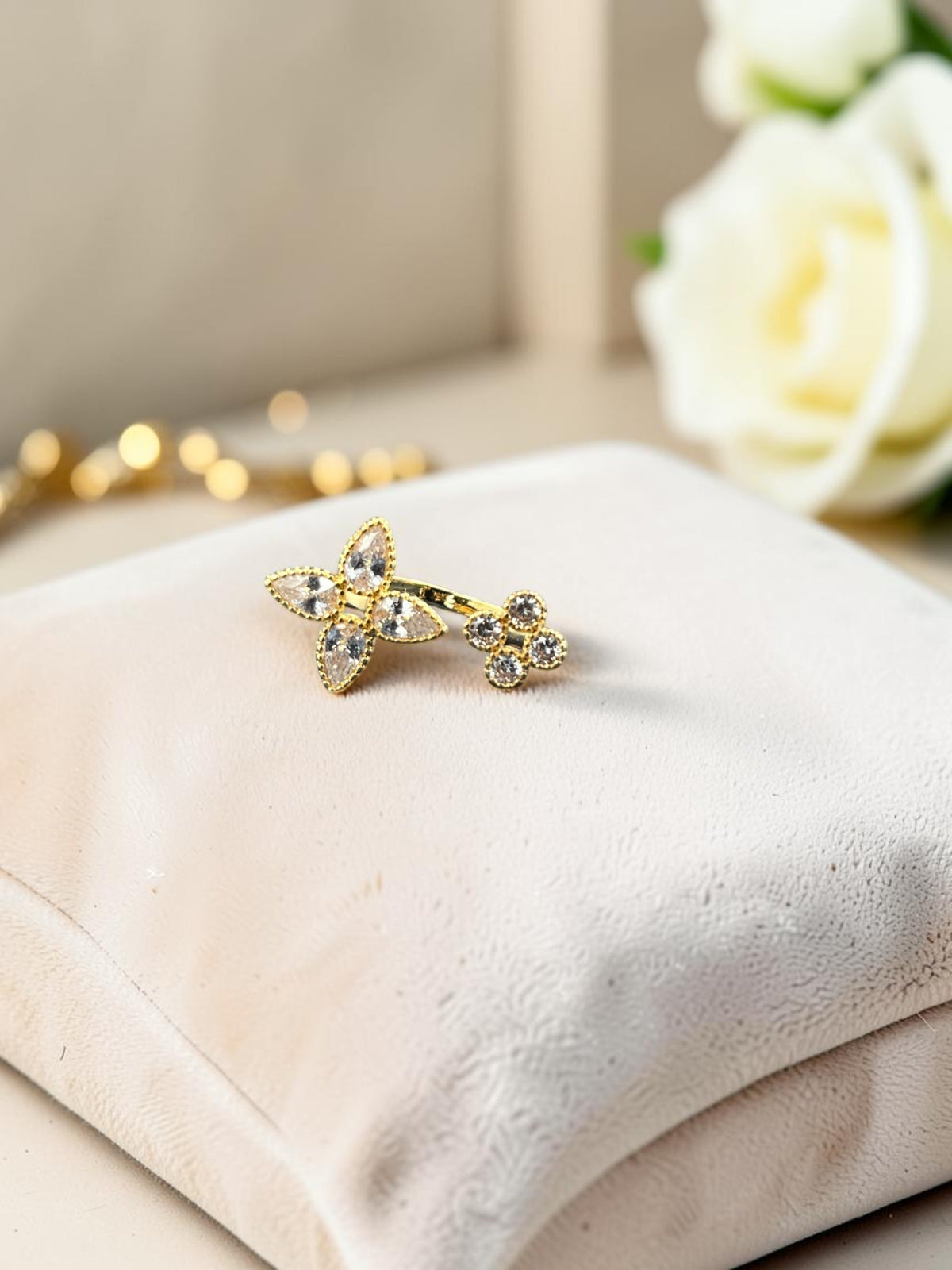 SHE BEAUTY anti-tarnish gold-toned ring featuring a floral design with sparkling AD stones on a velvet cushion.