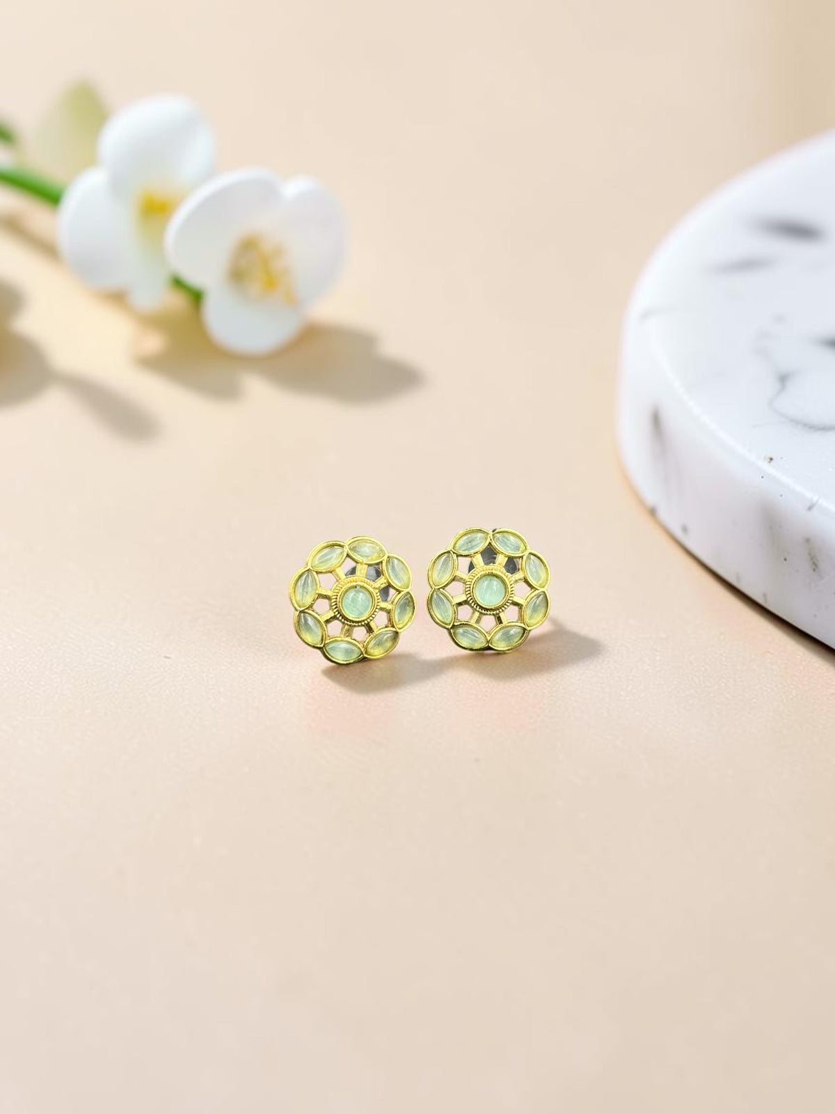 SHE BEAUTY gold-toned floral stud earrings with light green cabochon stones for ethnic and contemporary outfits