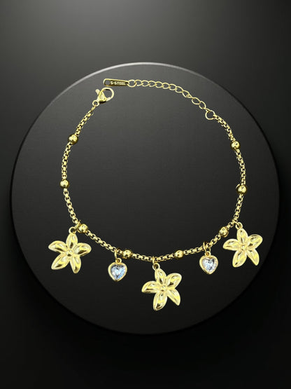 SHE BEAUTY KIYU ZIYU gold-tone chain bracelet featuring flower and heart charms for festive or everyday wear.