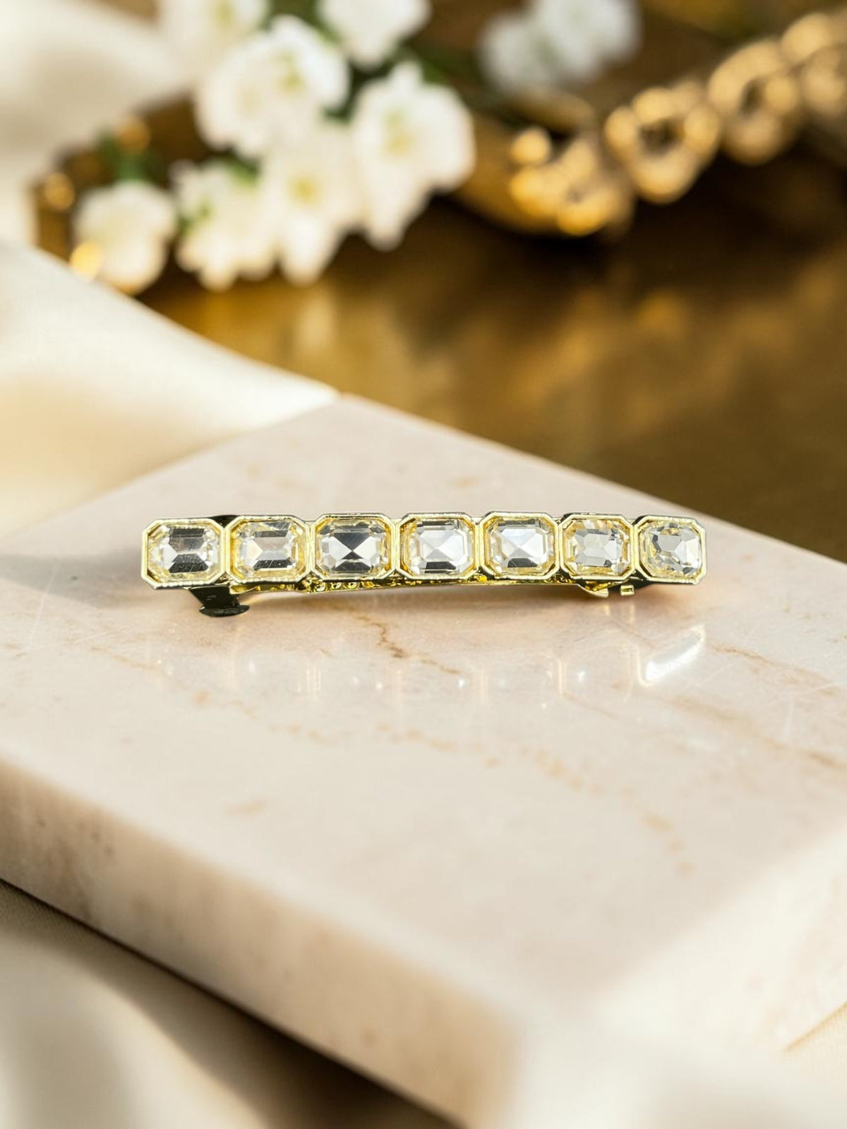SHE BEAUTY gold-tone barrette featuring seven rectangular clear gemstones, perfect for festive or everyday hairstyles.