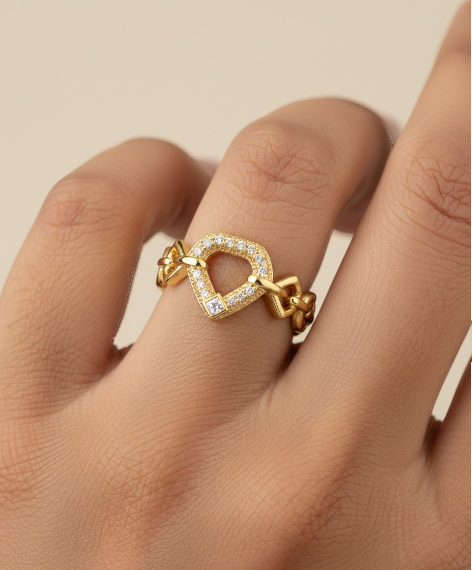 SHE BEAUTY gold-toned anti-tarnish ring featuring a geometric heart-shaped center with sparkling AD stone accents.