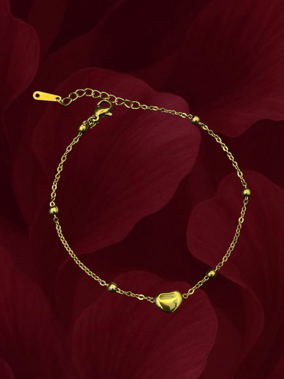 SHE BEAUTY KIYU ZIYU gold-toned chain anklet featuring a small polished heart charm and delicate bead accents.