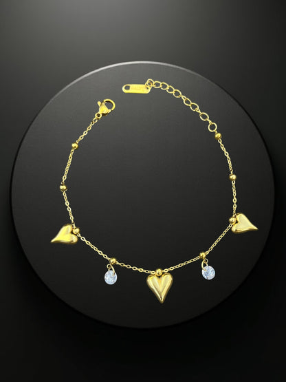 SHE BEAUTY KIYU ZIYU gold-tone chain bracelet featuring heart charms and sparkling crystal accents for festive wear.