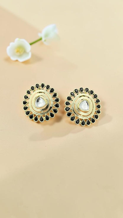 SHE BEAUTY gold-toned kundan stud earrings featuring a central clear stone surrounded by black teardrop accents