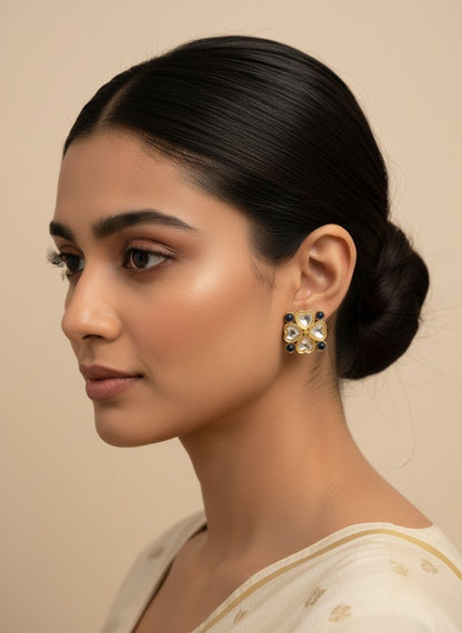 SHE BEAUTY gold-toned kundan tops with blue stone accents worn by a woman in a side profile view