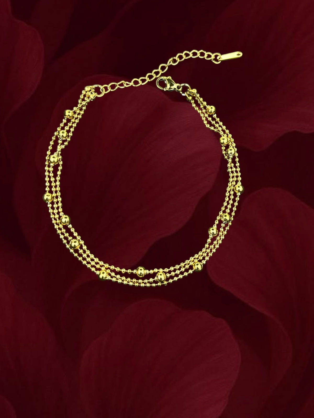 SHE BEAUTY KIYU ZIYU gold-toned layered chain anklet with delicate beads for festive and party wear.