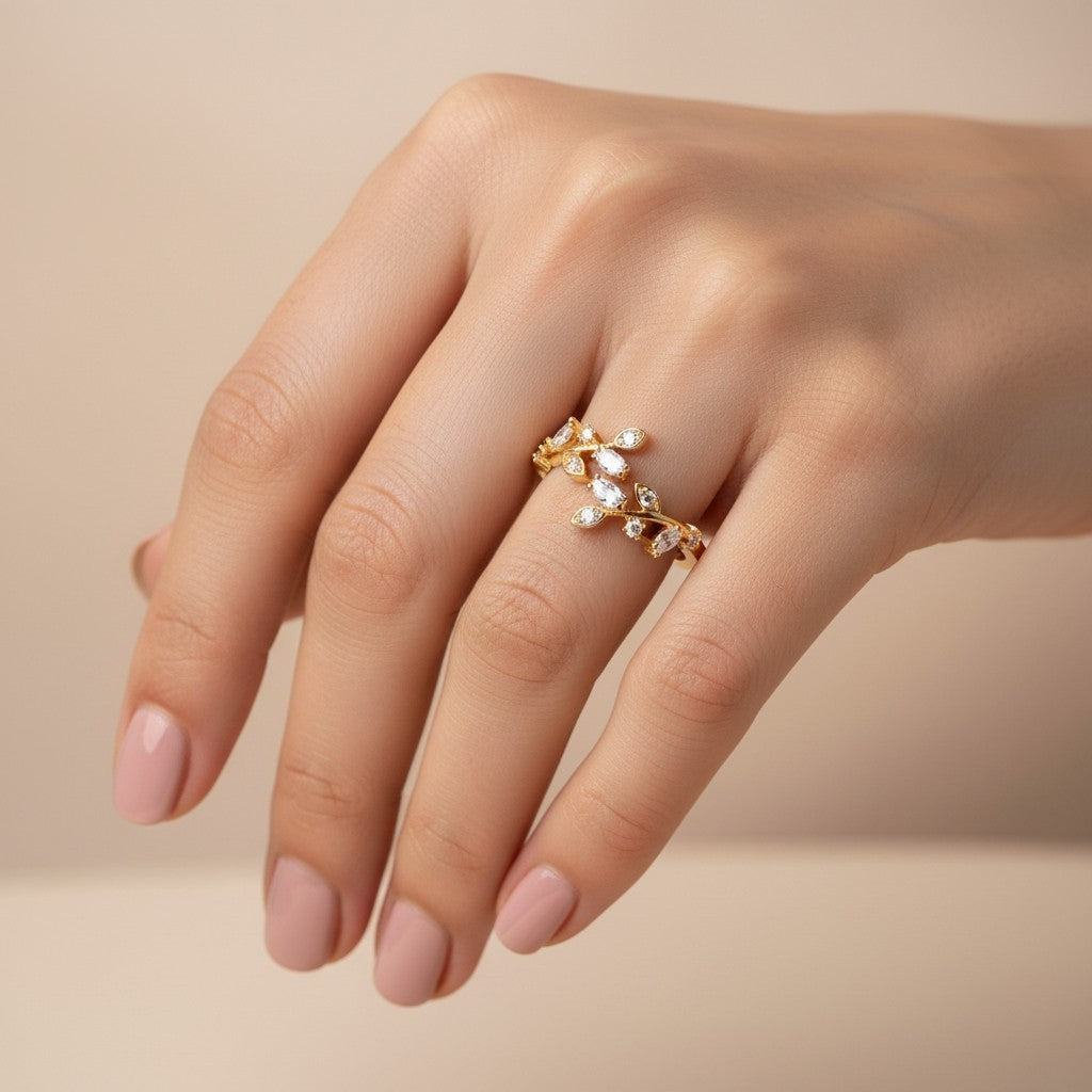 SHE BEAUTY gold-toned anti-tarnish ring featuring a delicate leaf design with sparkling marquise-cut AD stones.