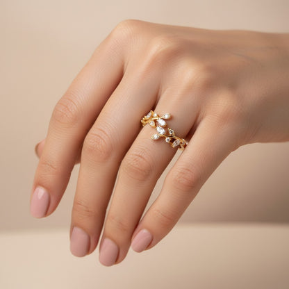 SHE BEAUTY gold-toned anti-tarnish ring featuring a delicate leaf design with sparkling marquise-cut AD stones.