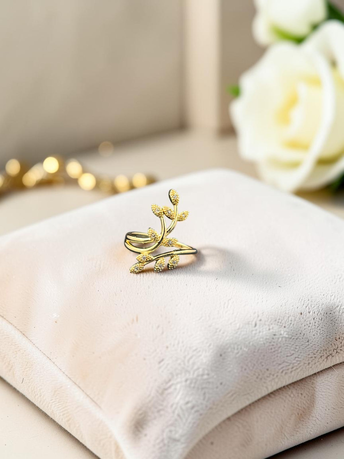 SHE BEAUTY gold-toned anti-tarnish ring featuring a delicate leaf design with sparkling AD stone accents