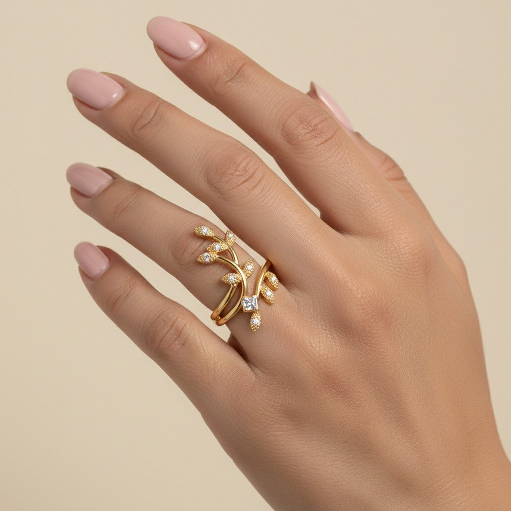 SHE BEAUTY gold-toned anti-tarnish ring featuring a delicate leaf design with sparkling AD stones on a hand