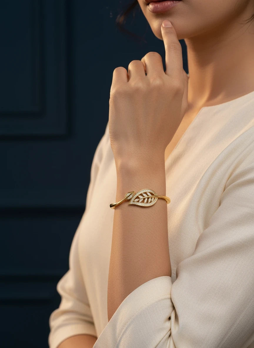 SHE BEAUTY anti-tarnish gold bracelet featuring a delicate leaf design with sparkling zirconia stones on a model