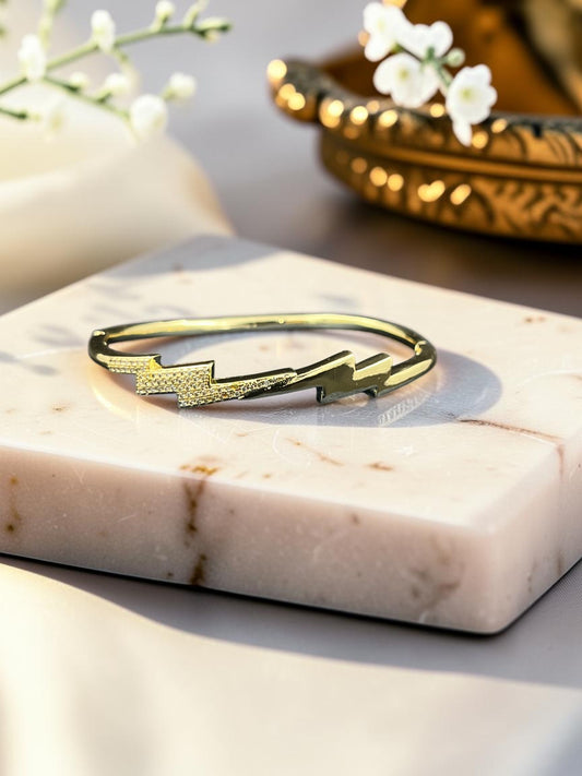SHE BEAUTY anti-tarnish gold-tone bracelet featuring a stylish lightning bolt design with sparkling AD stones.