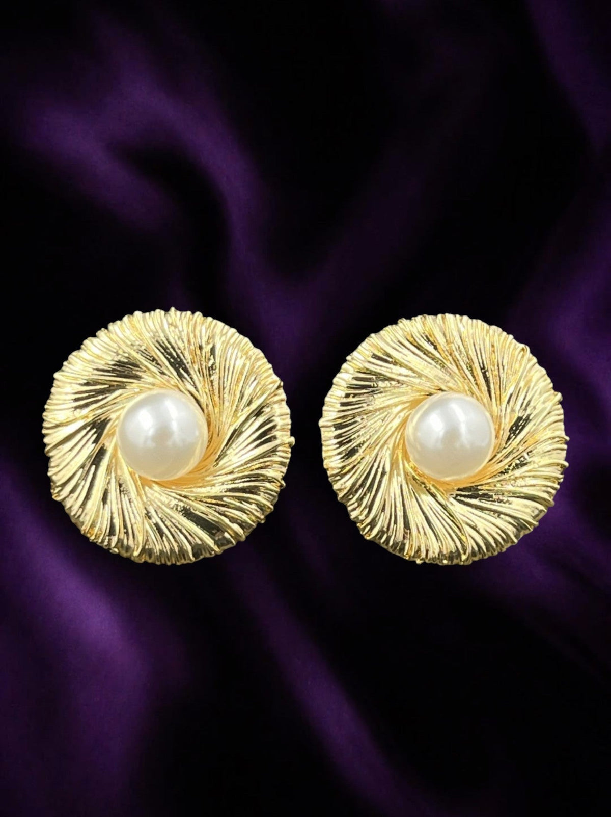 SHE BEAUTY anti-tarnish gold-toned stud earrings featuring a textured swirl design and a central white pearl