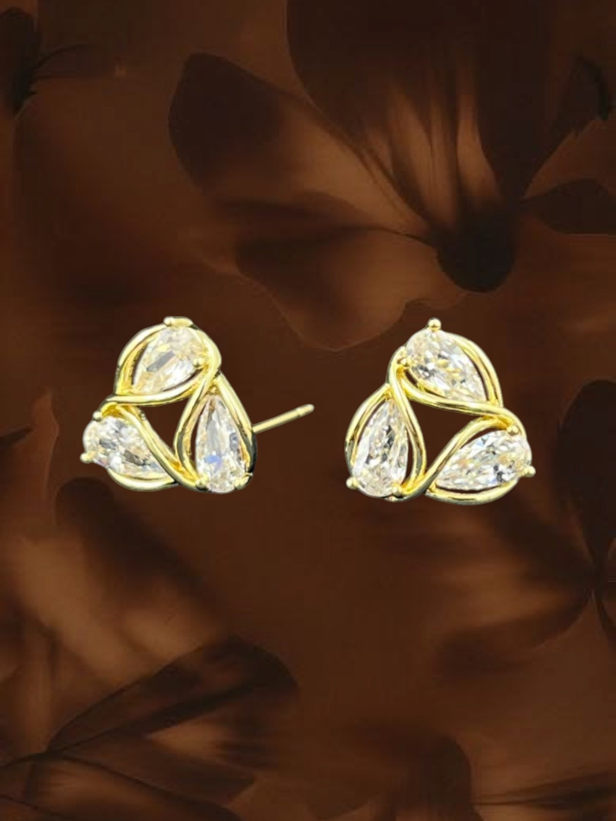 SHE BEAUTY AD petal pendant earrings featuring clear teardrop stones set in a gold-toned metal floral design