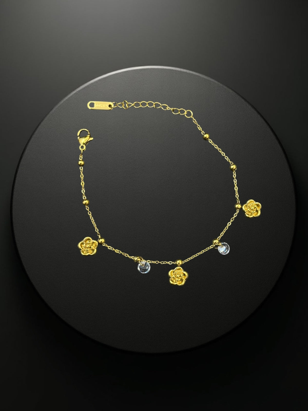 SHE BEAUTY KIYU ZIYU gold-tone chain bracelet featuring delicate rose charms and sparkling crystal accents.