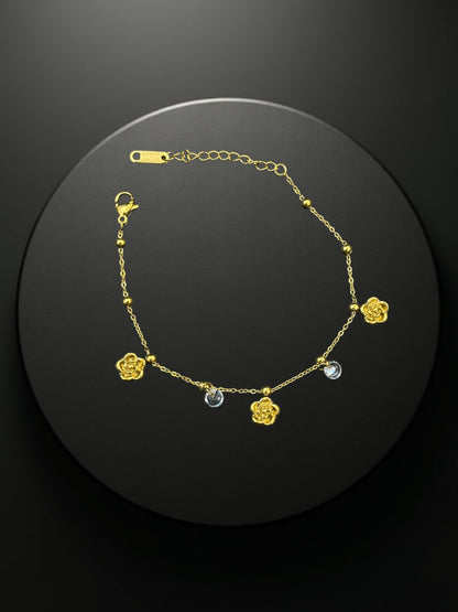 SHE BEAUTY KIYU ZIYU gold-tone chain bracelet featuring delicate rose charms and sparkling crystal accents.