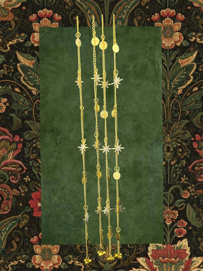 SHE BEAUTY gold-toned chain set featuring star charms, coin accents, and small bells for festive party wear