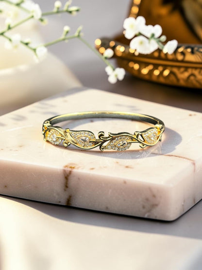SHE BEAUTY gold-toned anti-tarnish bracelet featuring intricate leaf-inspired filigree and sparkling zirconia stones.
