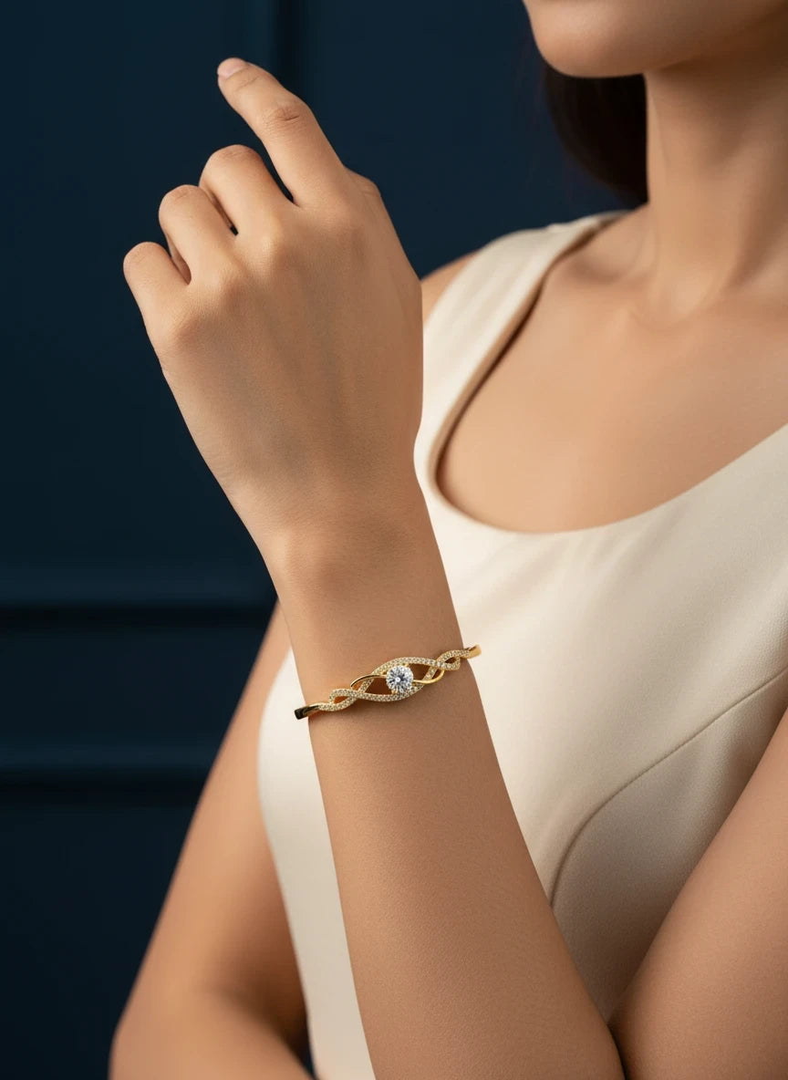 SHE BEAUTY gold-plated zirconia bracelet with a central stone and pavé accents worn on a woman's wrist