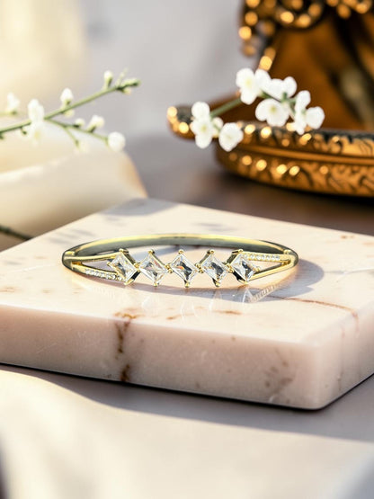 SHE BEAUTY anti-tarnish gold bracelet featuring five sparkling marquise-cut zirconia stones on a marble display.