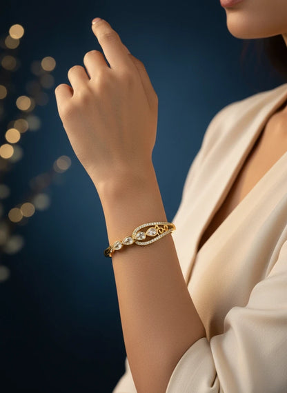 SHE BEAUTY gold-plated anti-tarnish bracelet featuring pear-cut zirconia stones on a model's wrist