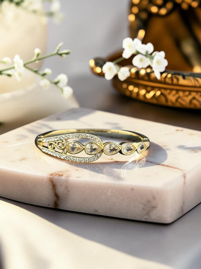 SHE BEAUTY gold-toned anti-tarnish bracelet featuring pear-shaped zirconia stones and intricate filigree detailing.
