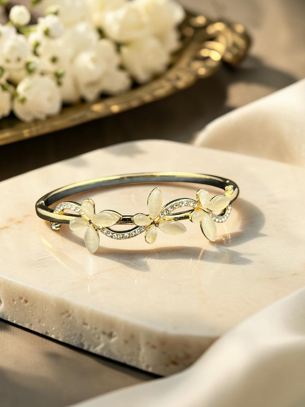 SHE BEAUTY gold-toned anti-tarnish bracelet featuring floral zirconia accents and smooth opal-like petals