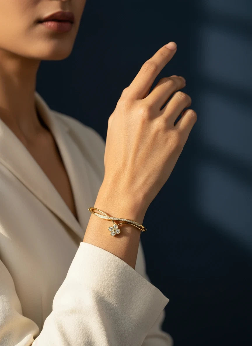 SHE BEAUTY anti-tarnish gold bracelet featuring a delicate flower charm with sparkling zirconia stones on a model