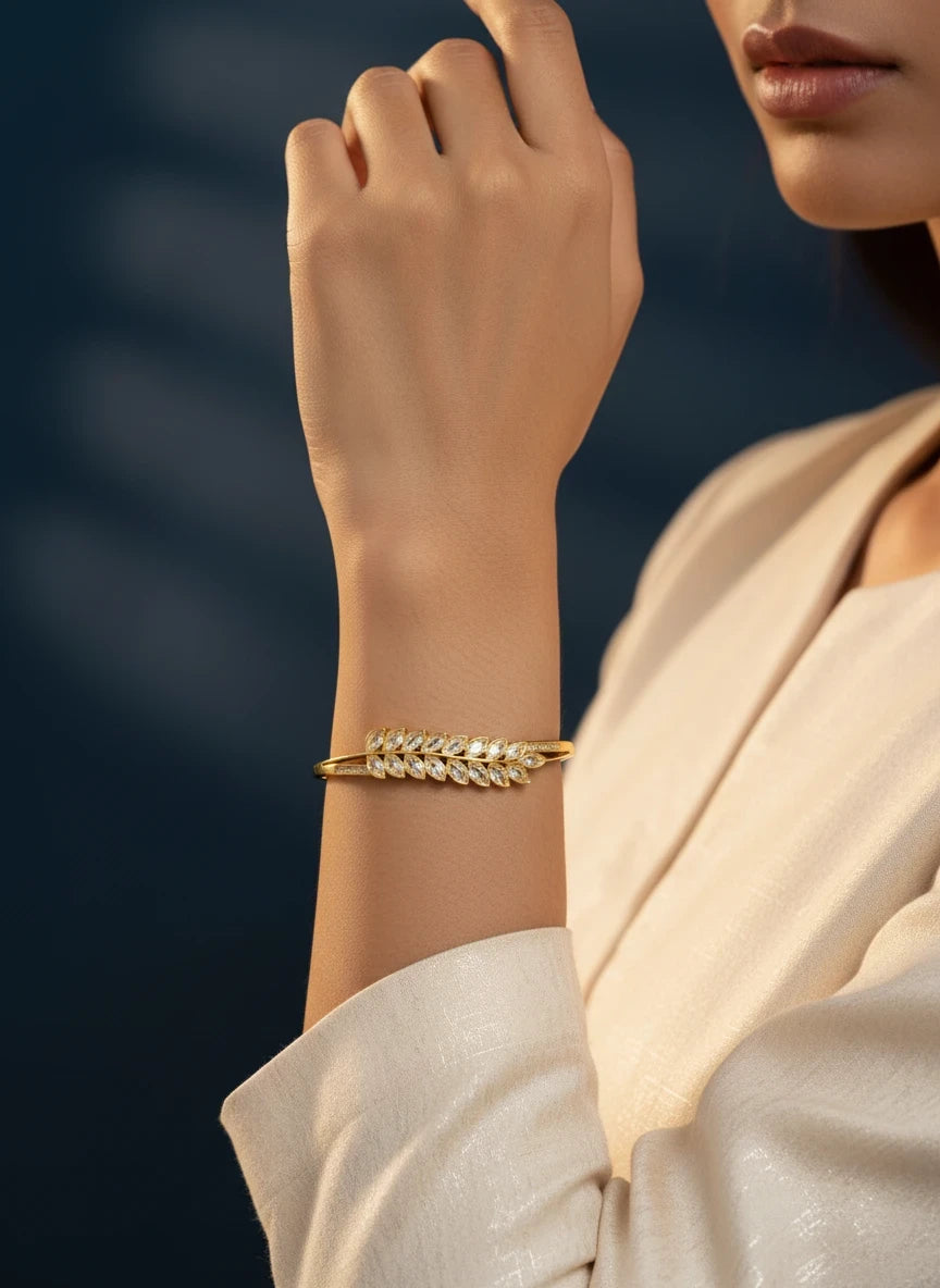 SHE BEAUTY anti-tarnish gold bracelet featuring a delicate leaf-shaped design with sparkling zirconia stones on wrist