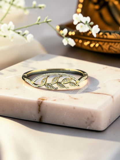 SHE BEAUTY gold-toned anti-tarnish bracelet featuring a delicate leaf design encrusted with sparkling zirconia stones.