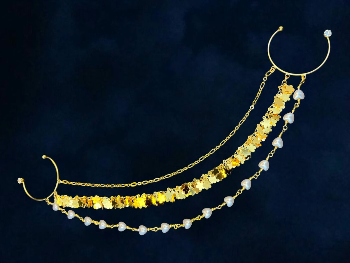 SHE BEAUTY golden braid pearl loop hair accessory with layered chains, floral charms, and white pearls on dark blue