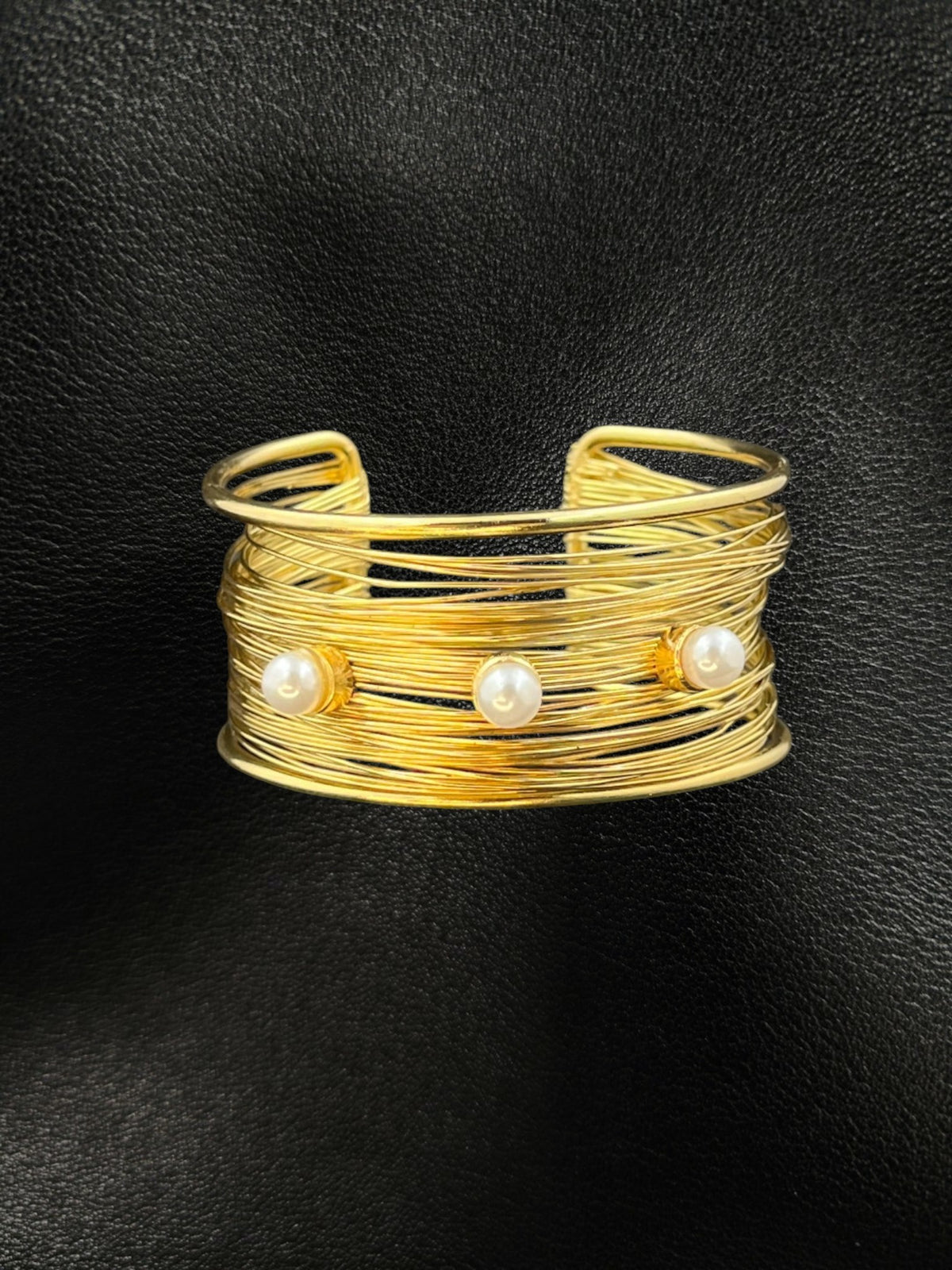 SHE BEAUTY golden multilayer cuff bracelet featuring three elegant pearls on a textured wire design