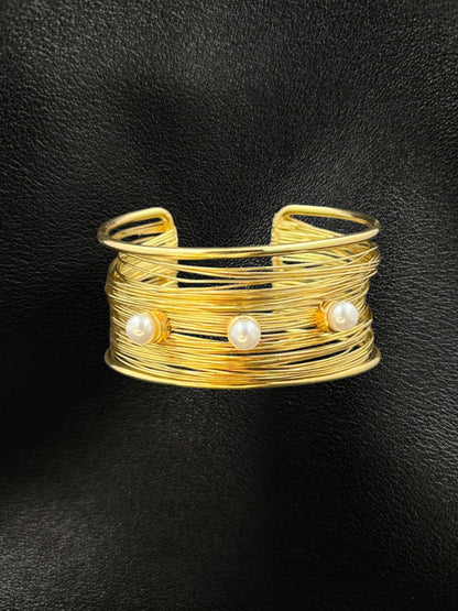 SHE BEAUTY golden multilayer cuff bracelet featuring three elegant pearls on a textured wire design