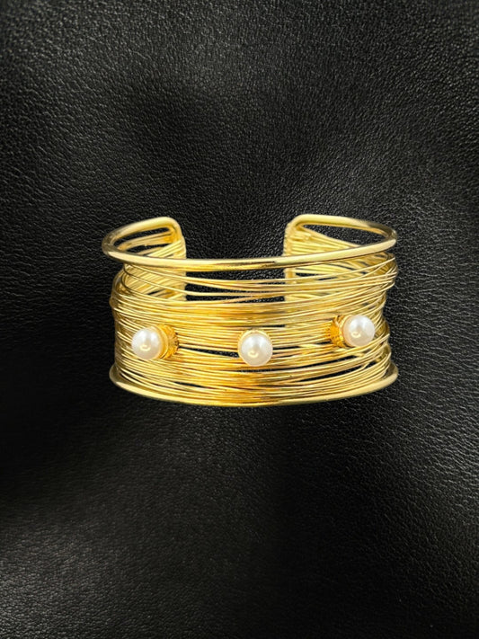 SHE BEAUTY golden multilayer cuff bracelet featuring three elegant pearls on a textured wire design