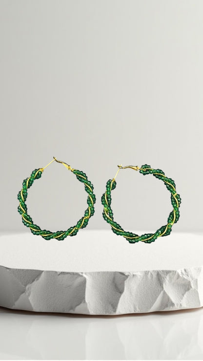 SHE BEAUTY Girlish Crystal Bali hoop earrings featuring twisted green crystal beads on a gold-tone wire frame.