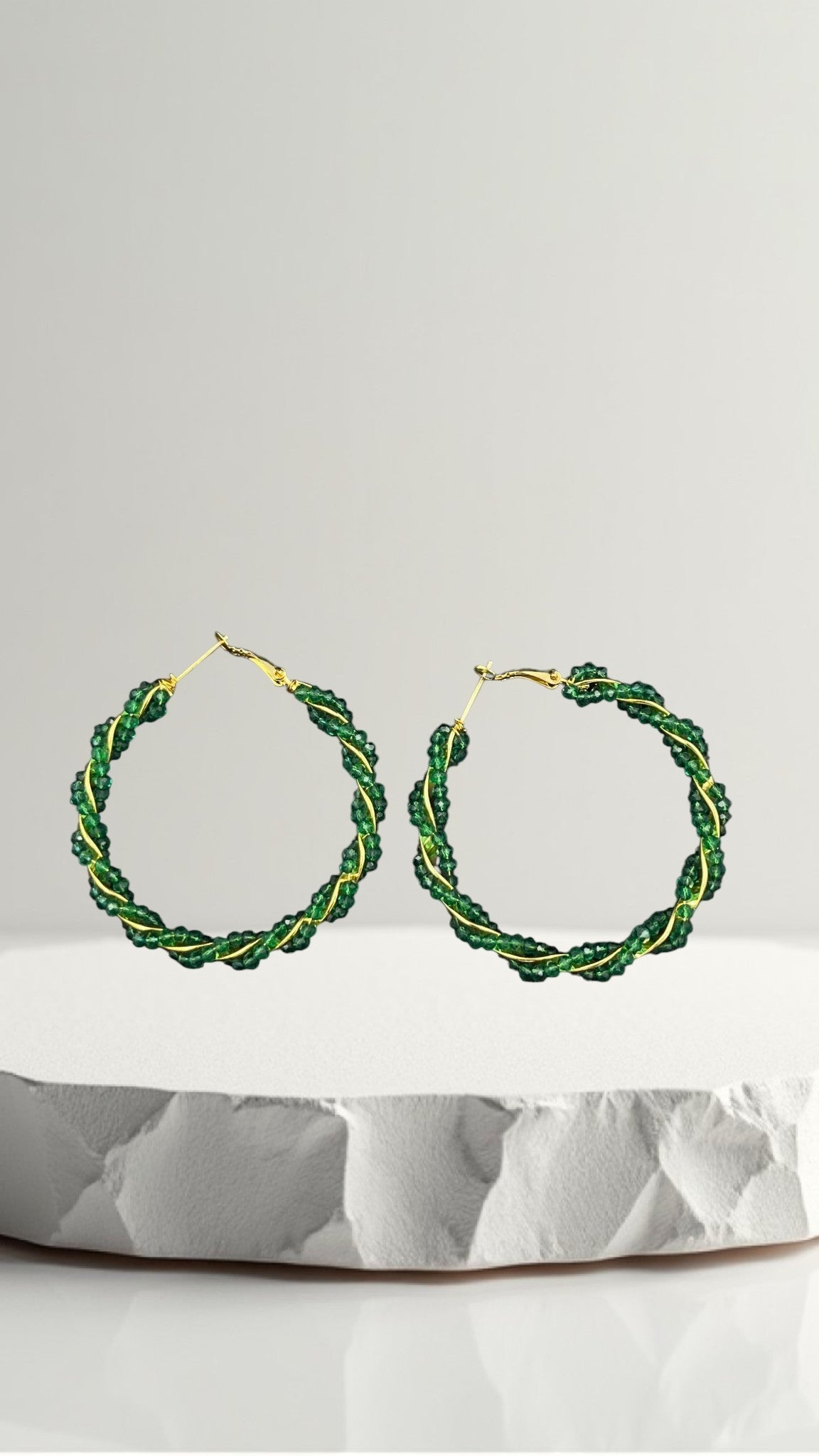 SHE BEAUTY Girlish Crystal Bali hoop earrings featuring twisted green crystal beads on a gold-tone wire frame.