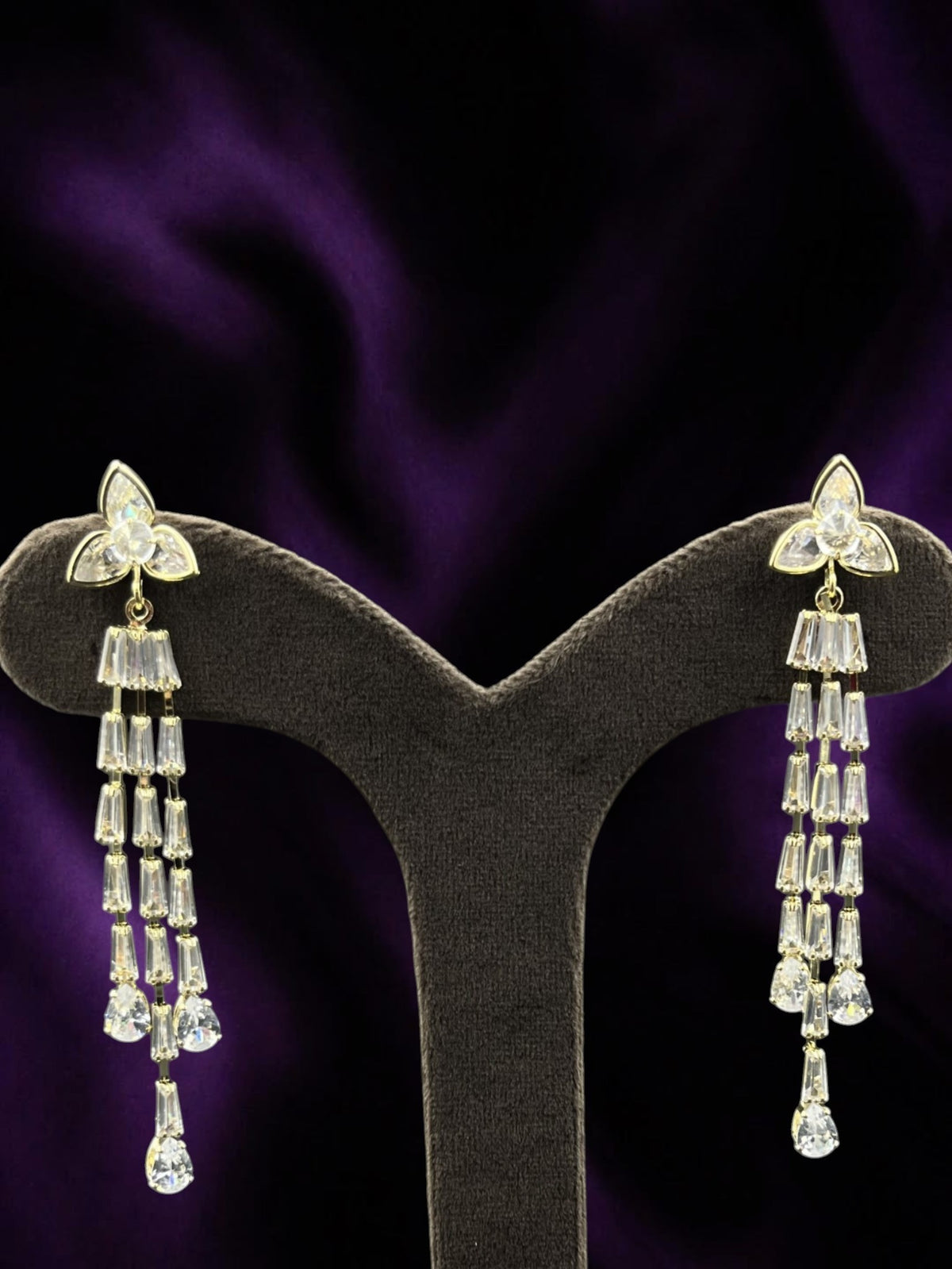 SHE BEAUTY ICY VINES gold-toned drop earrings featuring sparkling baguette and pear-cut crystals for festive wear.