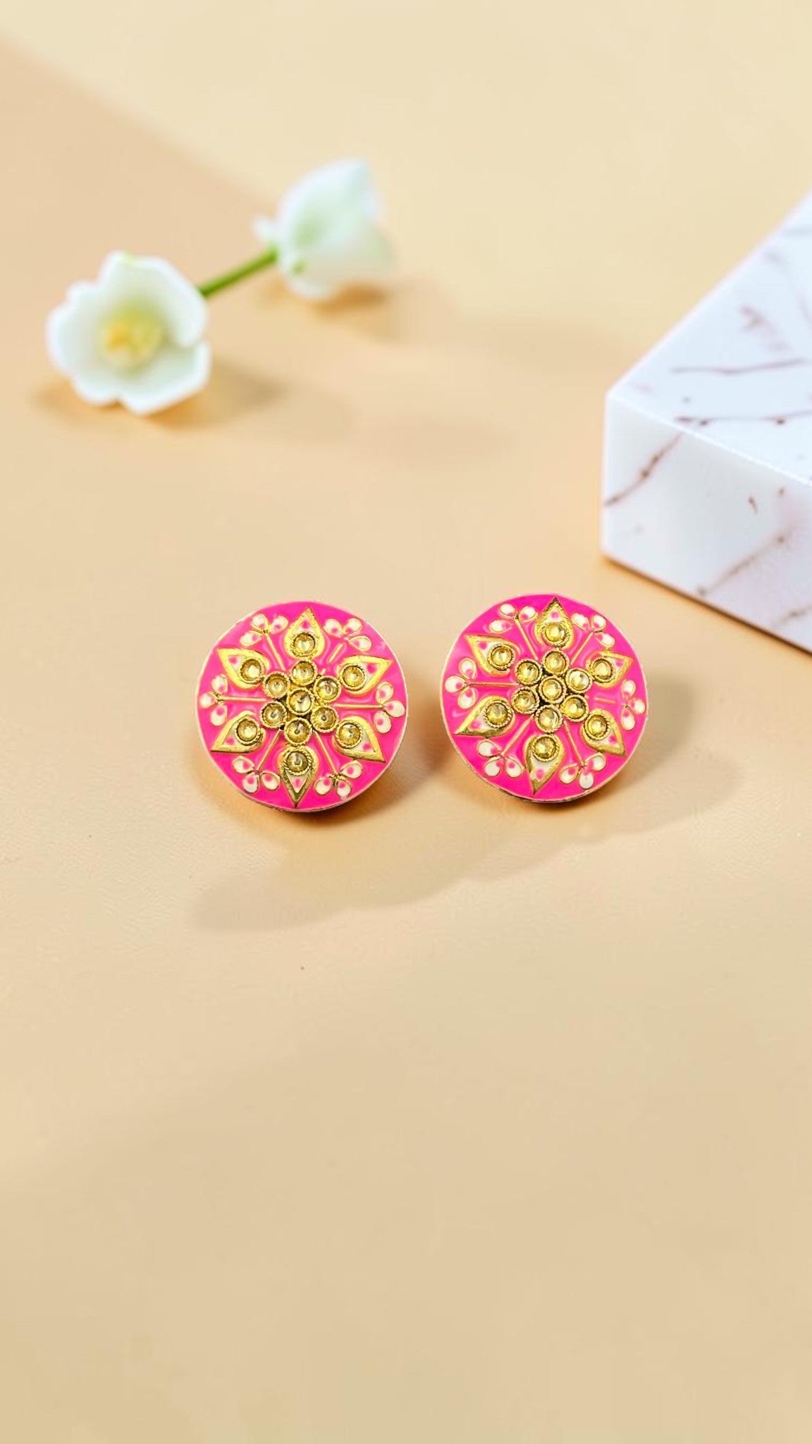 SHE BEAUTY Jaipuri round tops featuring vibrant pink enamel with intricate gold floral patterns and central crystals.
