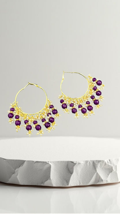SHE BEAUTY Kashmiri Bali hoop earrings featuring purple beads and delicate white pearl accents on a gold frame.