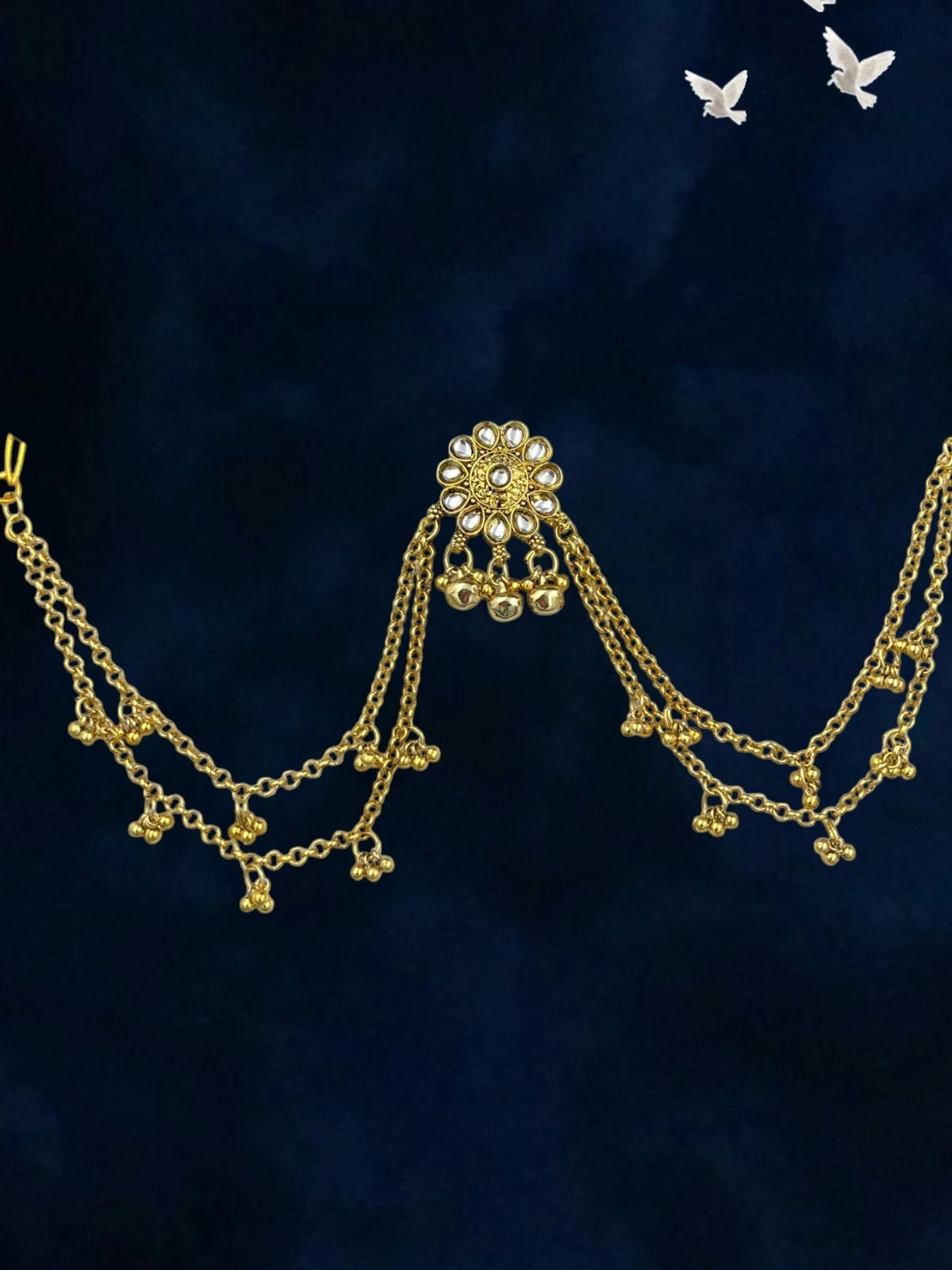 SHE BEAUTY Kashmiri gold-toned chain hair accessory featuring a floral kundan centerpiece and dangling bell charms