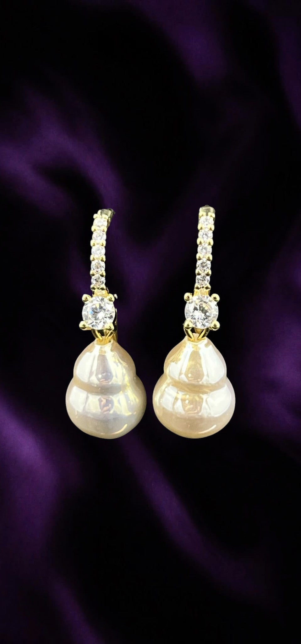 SHE BEAUTY Korean AD pearl drop earrings with gold-tone accents and sparkling cubic zirconia stones on purple silk