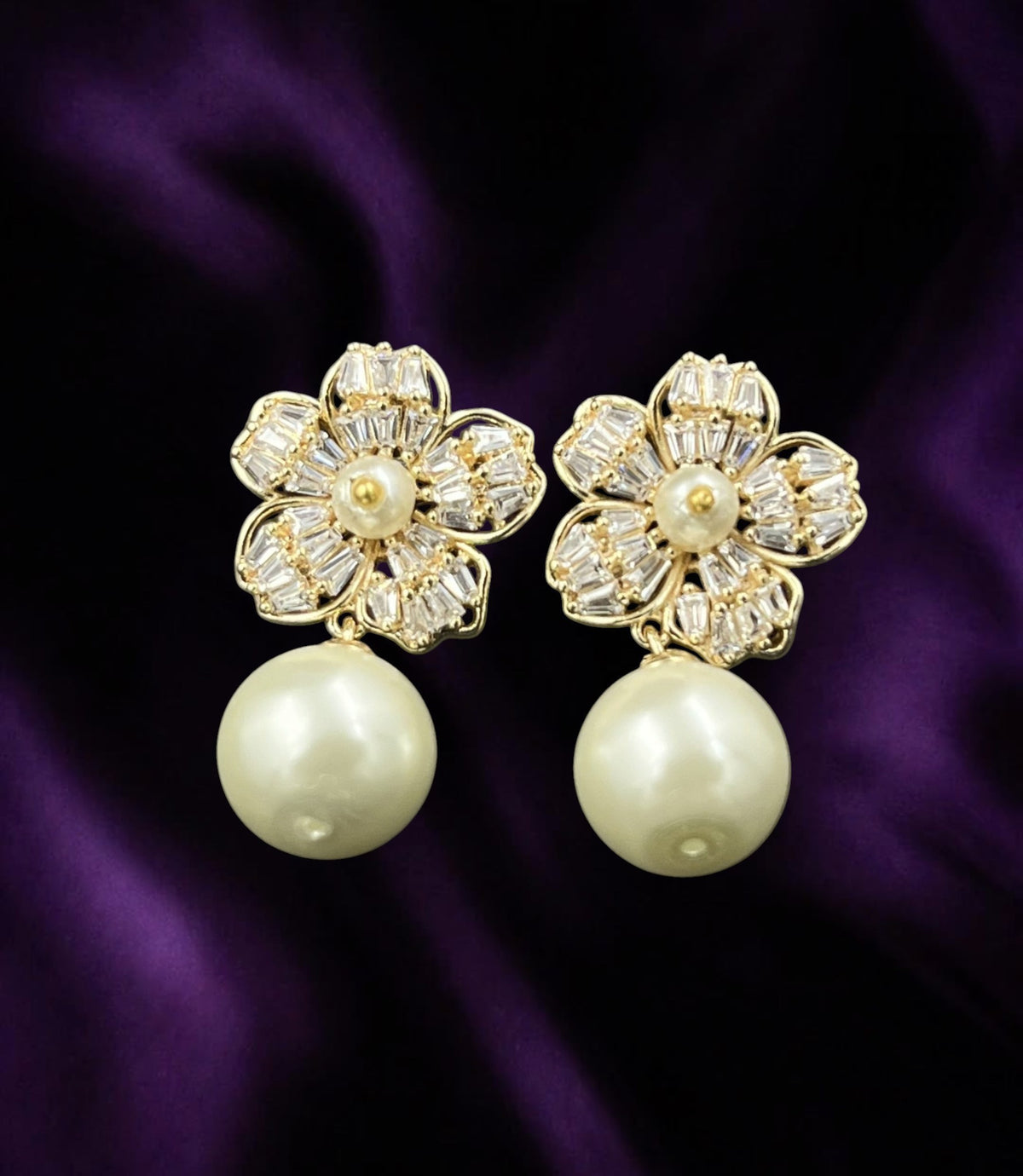 SHE BEAUTY Korean flower earrings featuring sparkling baguette crystals and a dangling cream pearl on purple silk