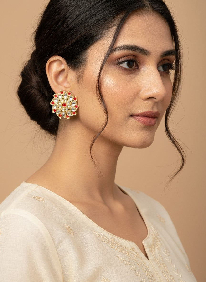SHE BEAUTY Royal Kundan gold stud earrings with red and white stones worn by a woman in a cream ethnic outfit