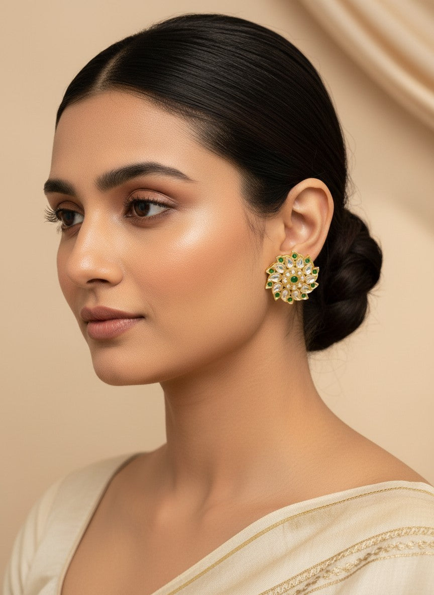 SHE BEAUTY Royal Kundan gold stud earrings with green stone accents worn by a woman in a neutral outfit