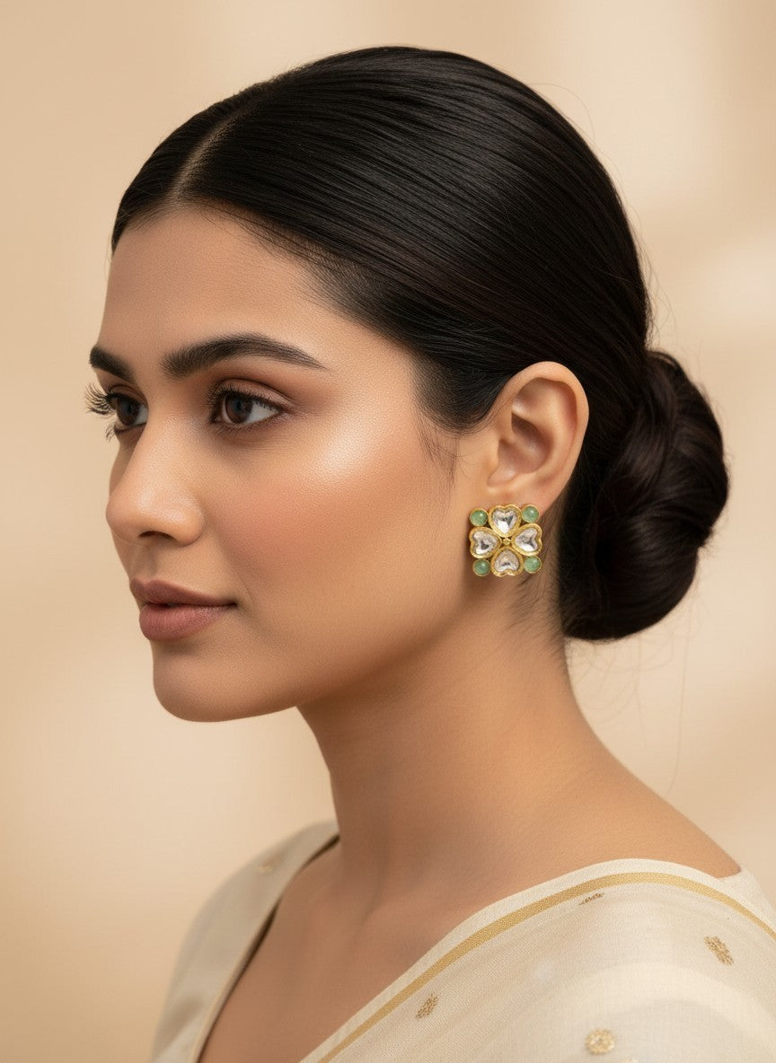 SHE BEAUTY light kundan tops featuring a floral-inspired gold setting with soft green stones worn by a model