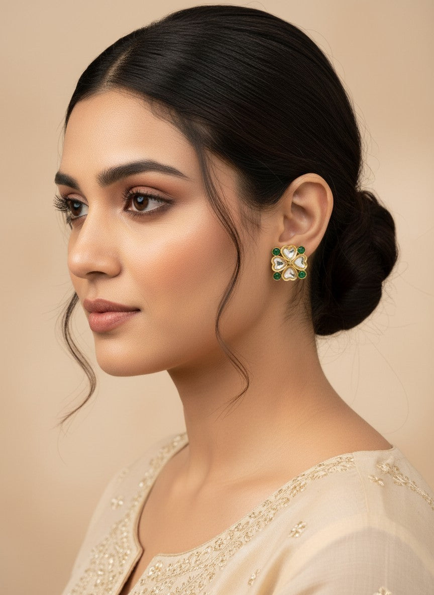 SHE BEAUTY light kundan tops featuring a floral design with clear stones and green accents worn by a woman