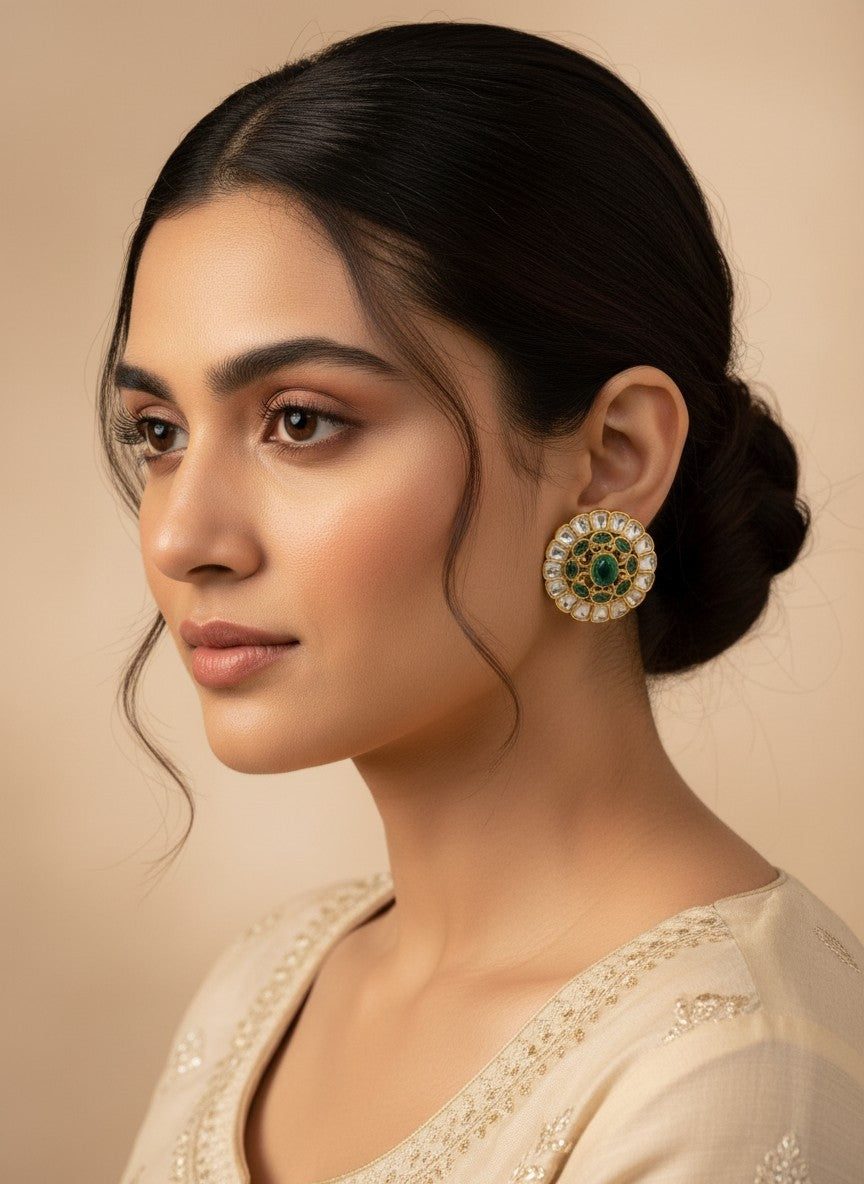 SHE BEAUTY Kundan tops featuring a round gold-tone design with a central green stone and white accents on a model