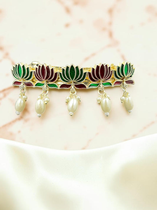 SHE BEAUTY lotus meenakari barrette featuring green and maroon enamel petals with dangling cream pearl accents.
